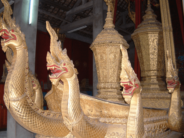 Ceremonial boat with carved Naga imagery in Luang Prabang